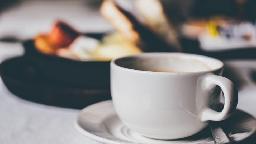 Free Image of Close-up of a cappuccino and breakfast 