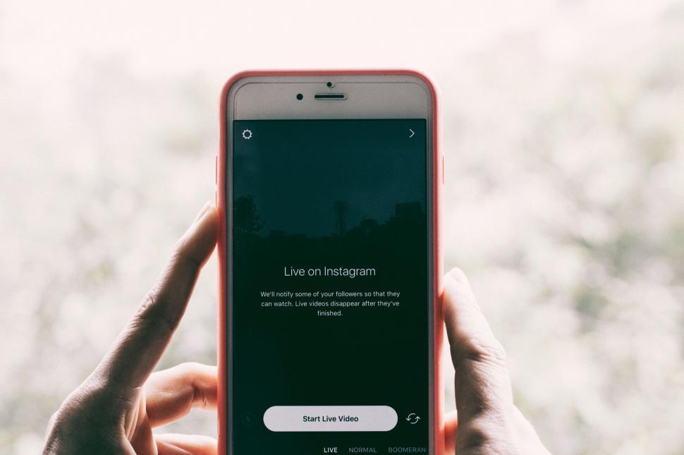 Free Image of Person holding red smartphone with Instagram 