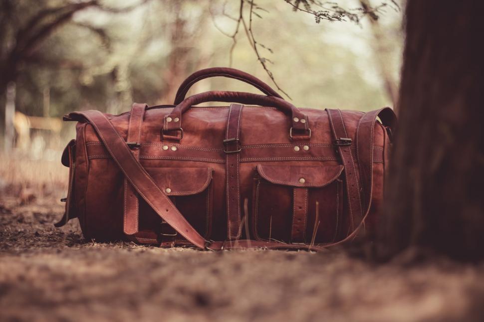 Free Image of Vintage leather bag in forest ambiance 