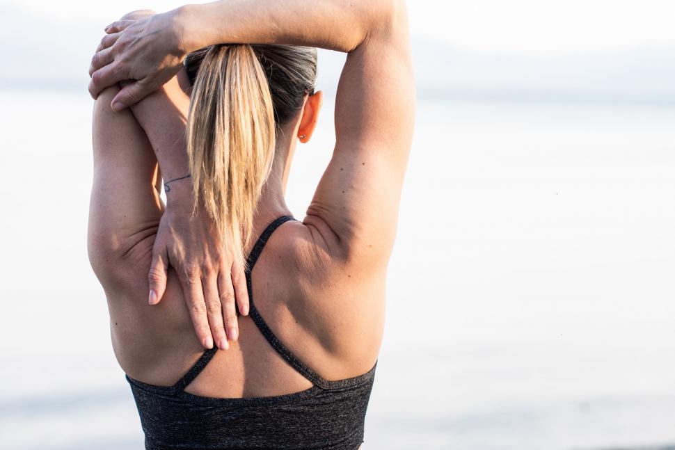 Woman stretching arms behind her back
