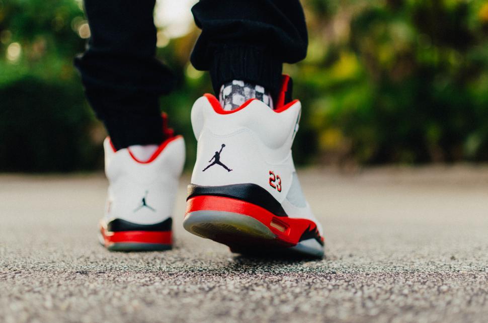 Free Image of Close-up of branded sneakers on pavement 