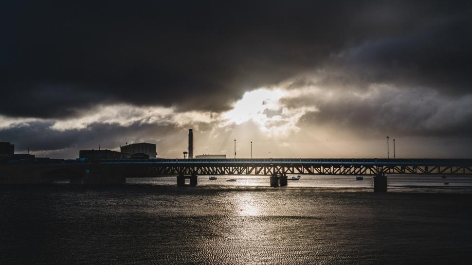 Free Image of Silhouetted cityscape against stormy sky 