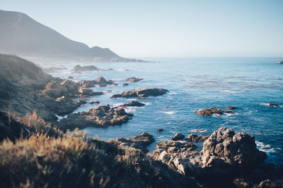 Free Image of Sunny coastal landscape with rocky shores 