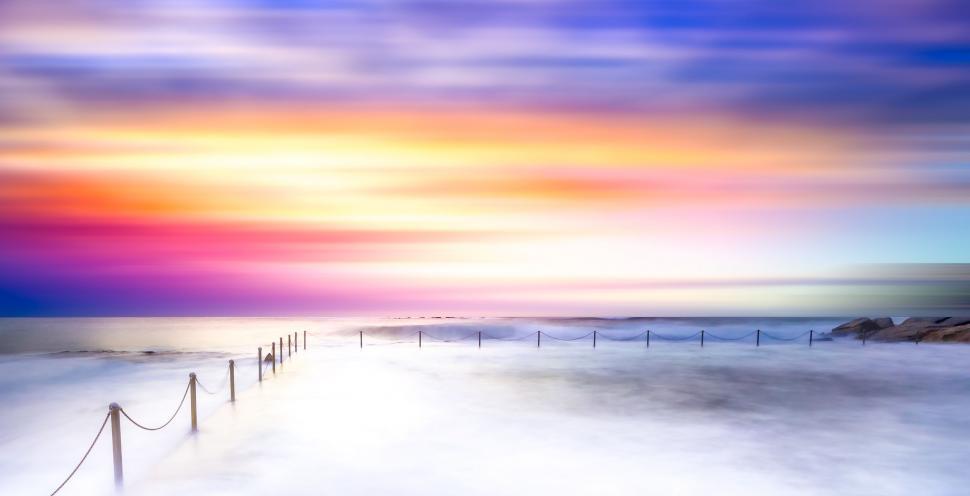 Free Image of Blurred oceanic landscape with vibrant skies 