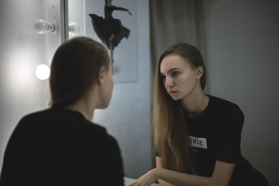 Free Image of Young woman reflecting in front of mirror 
