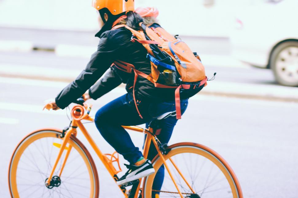 Free Image of Cyclist with child on city street 