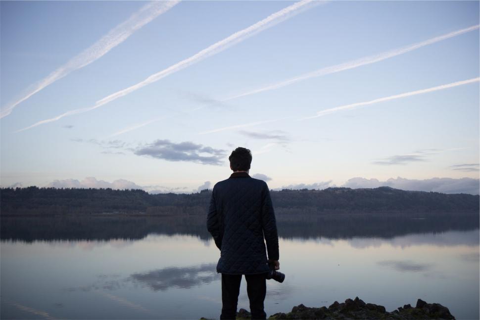 Free Image of Person gazing at a serene lake 