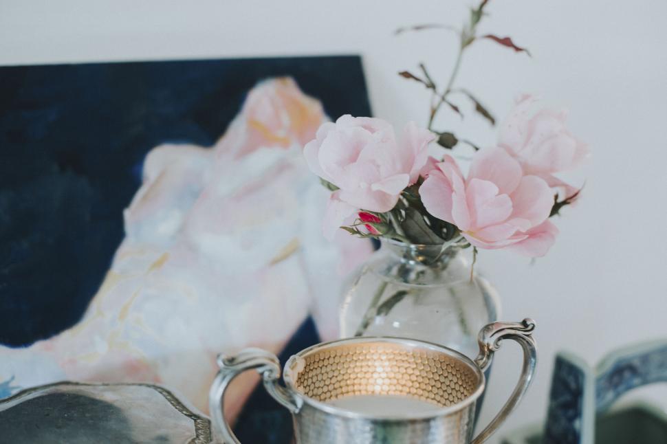 Free Image of Elegant still life with flowers and an artwork 