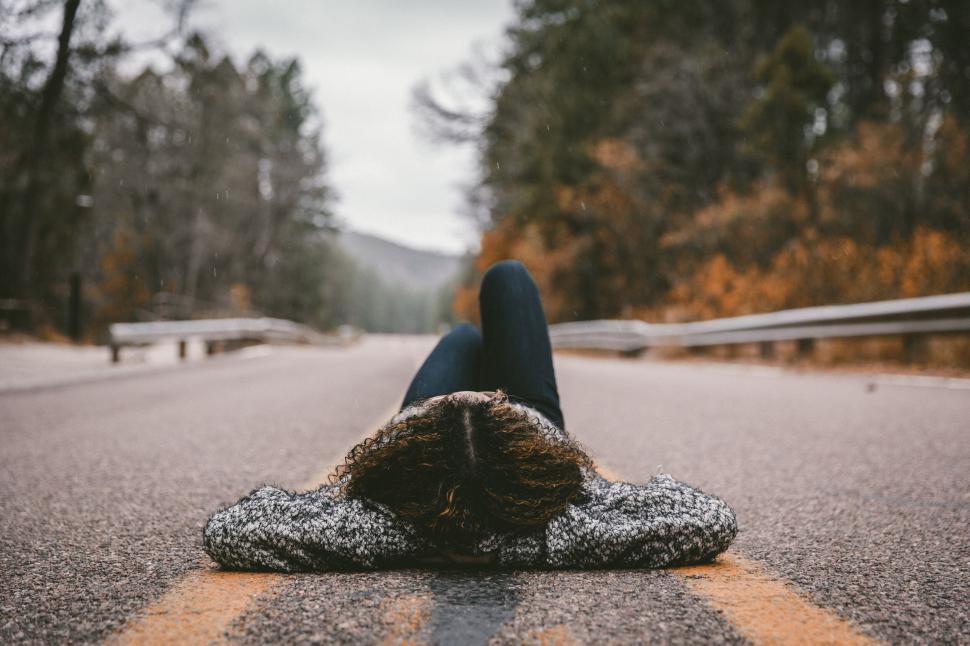 Free Image of Person lying on a road centerline 