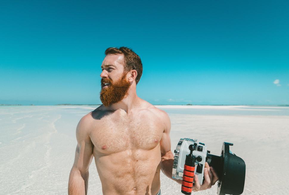 Free Image of Bearded man with camera on salt flats 