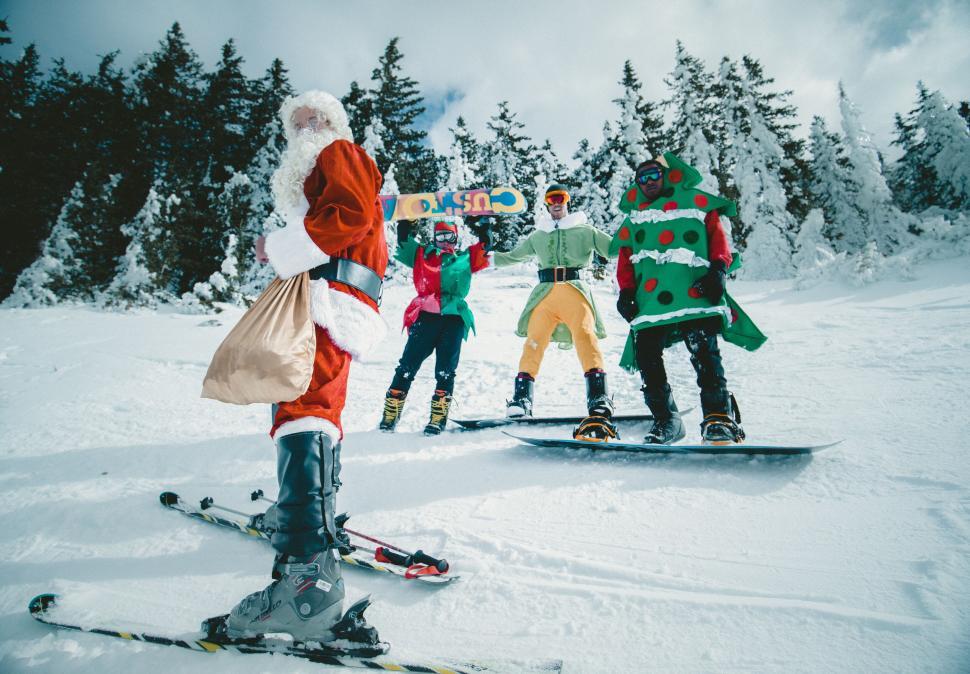 Free Image of Festive snowboarders with Santa Claus 