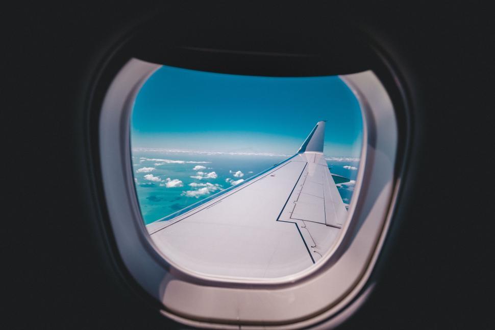 Free Image of View from airplane window showing wing 