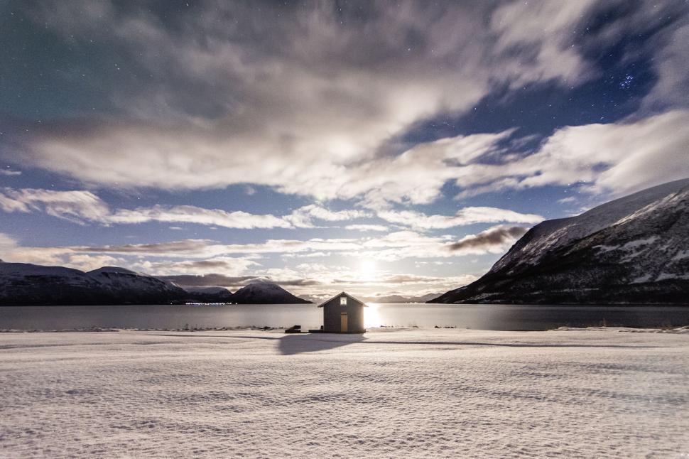 Free Image of Moonlit snowy landscape with a small hut 