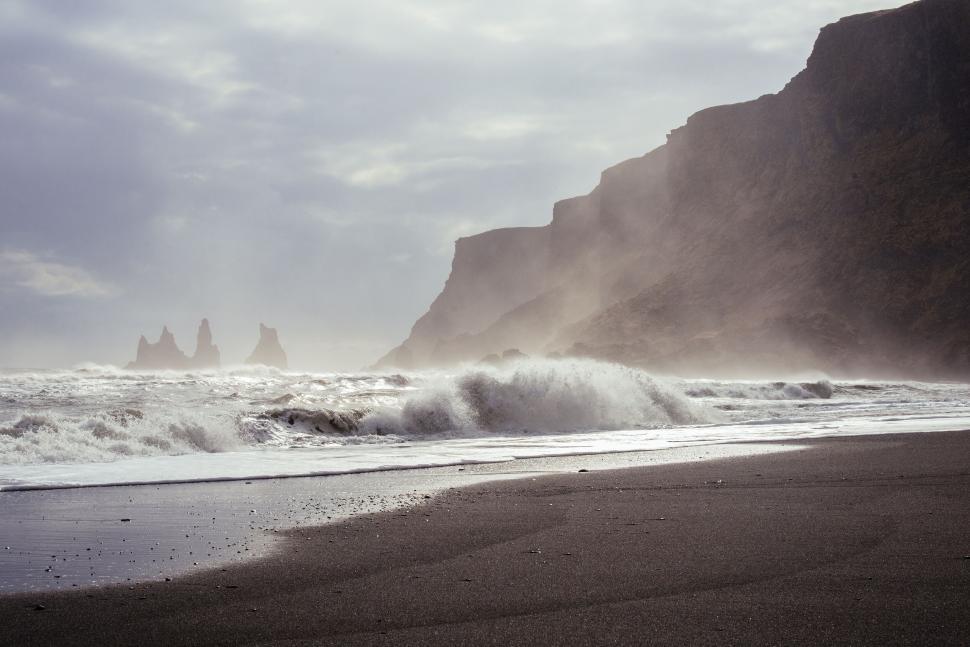 Free Image of Misty sea cliffs with crashing waves 