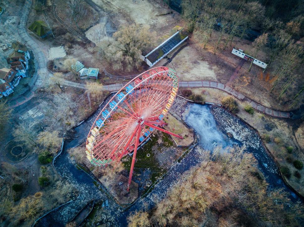 Free Image of Abandoned ferris wheel in overgrown park 