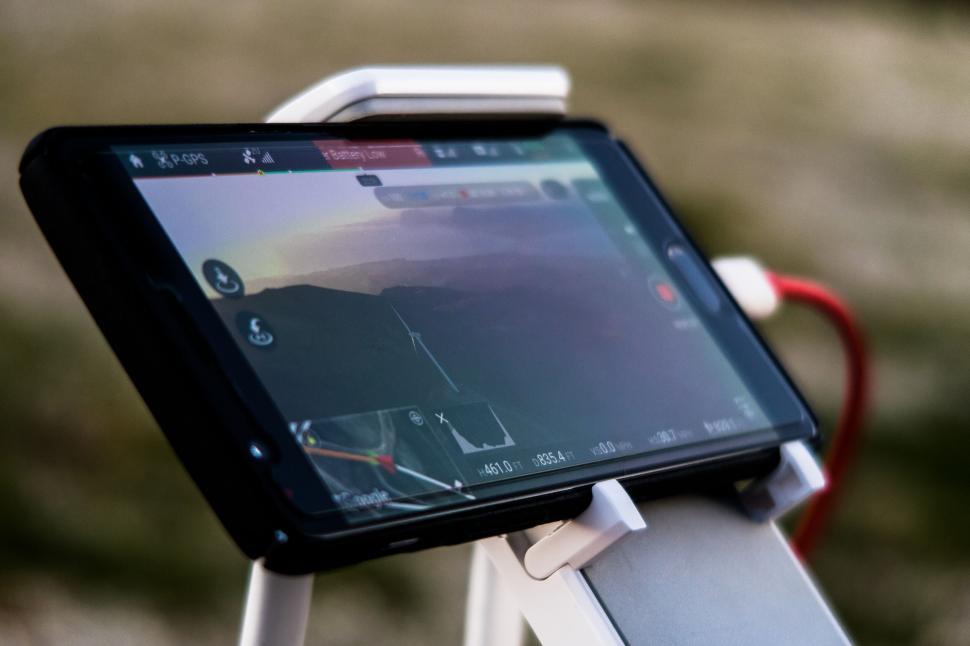Free Image of Drone controller with mountain view screen 