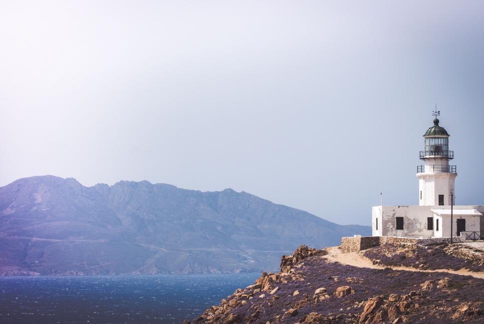 Free Image of Seaside lighthouse with mountains 