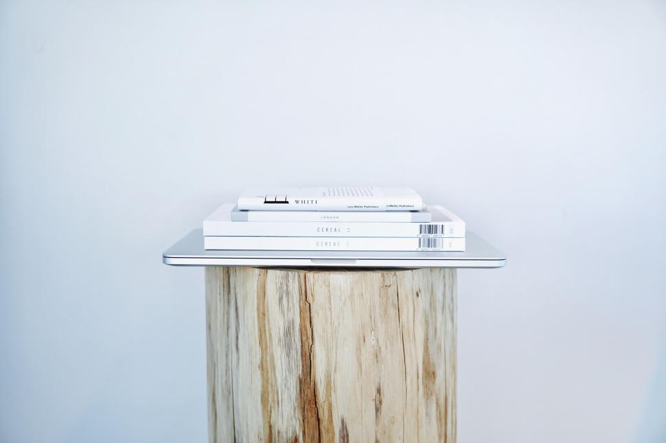Free Image of Books stacked on a minimalist stool 