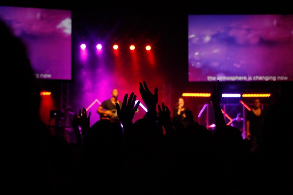 Free Image of Fans raising hands at a music event 