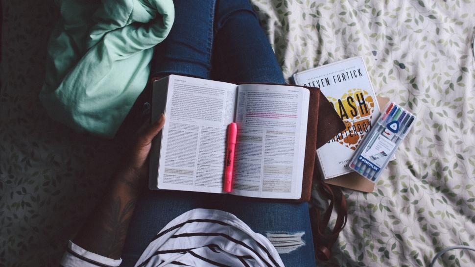 Free Image of Person studying with books and markers 