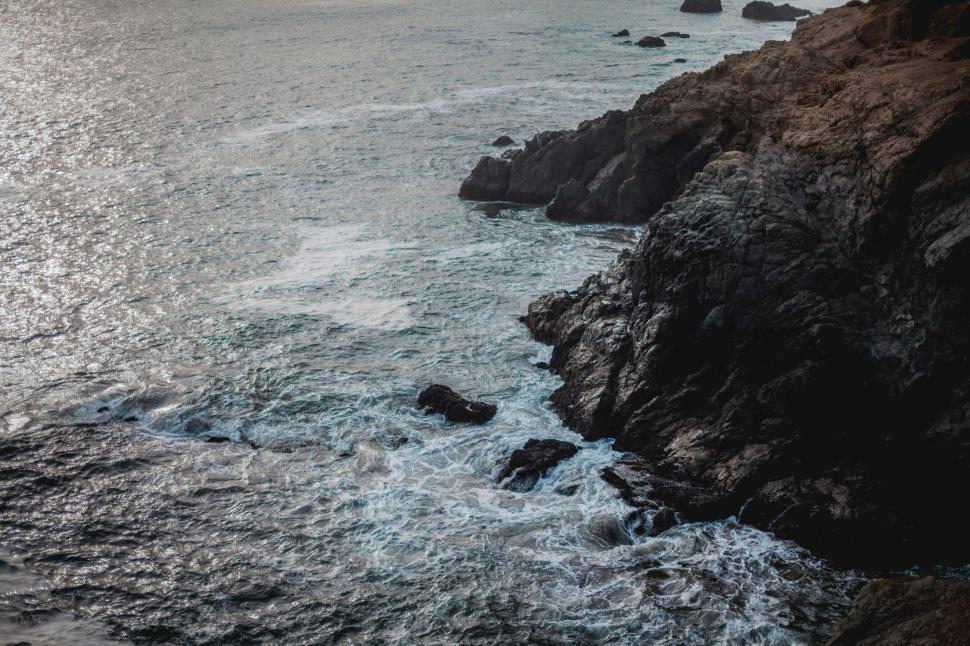 Free Image of Rugged coastline with foamy sea waves 