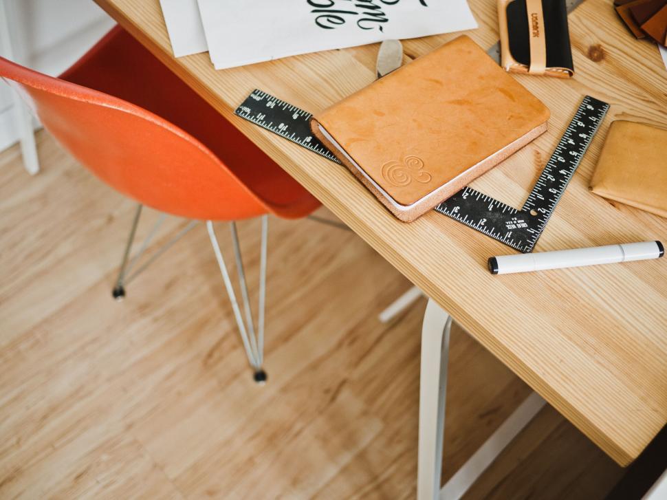 Free Image of Designer workspace with leather items 