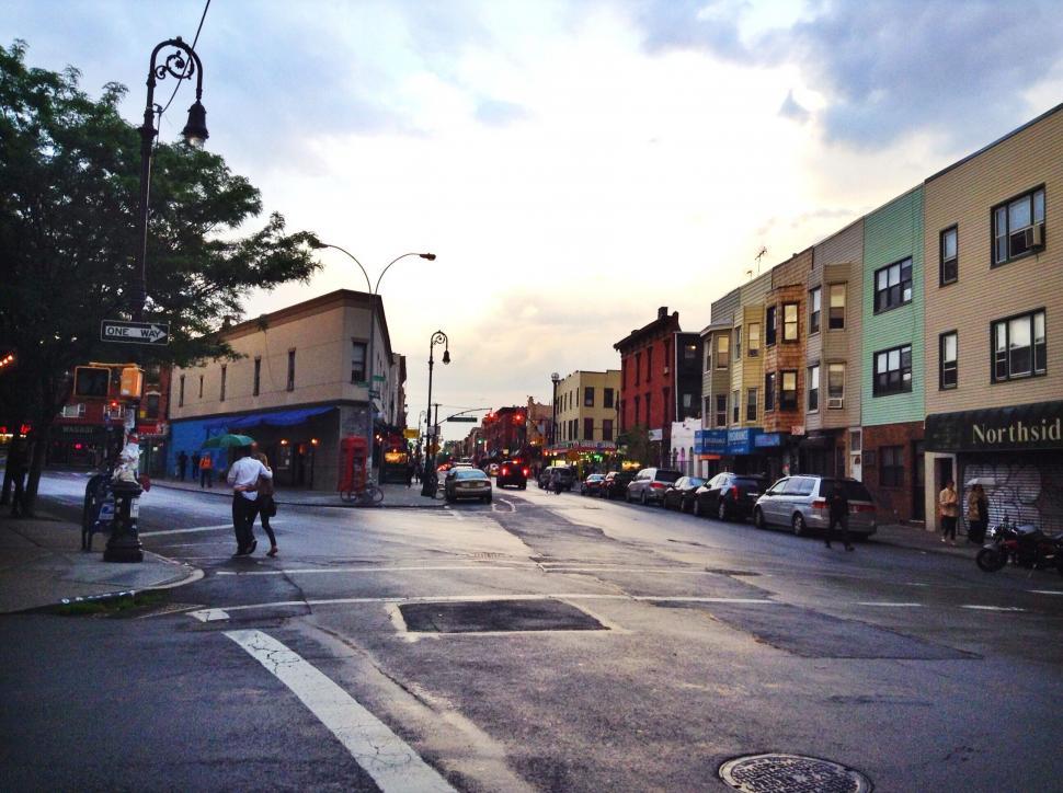 Free Image of Urban street at dusk with pedestrians 