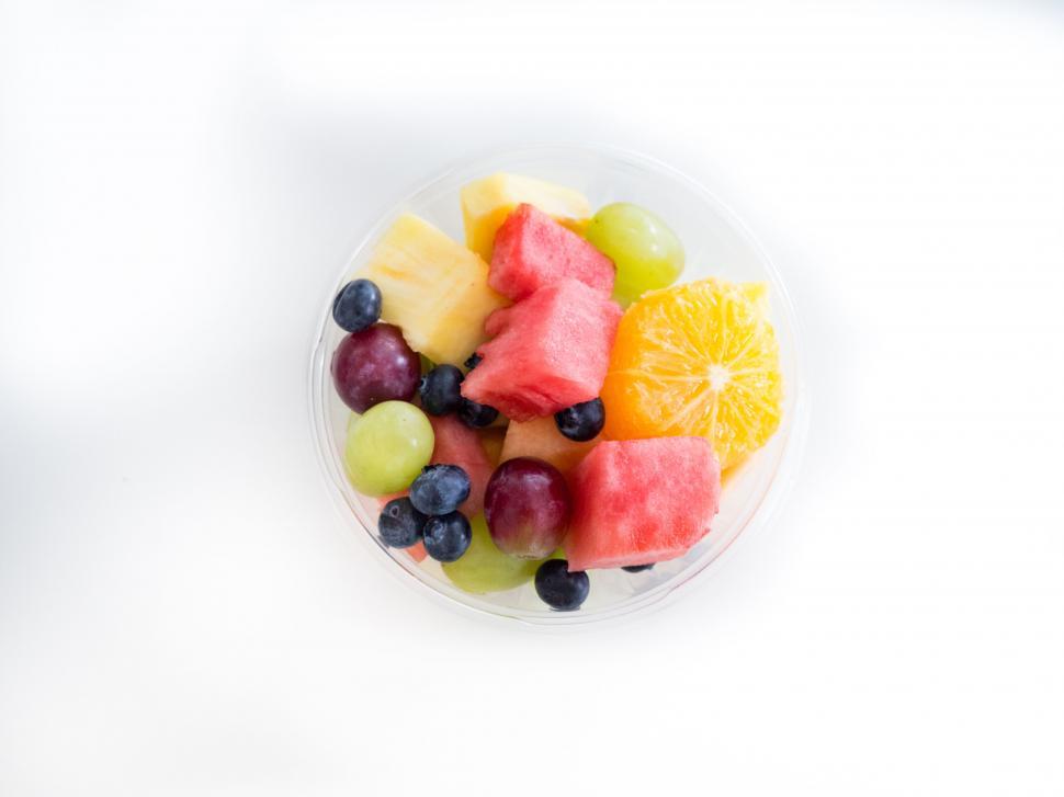 Free Image of Fruit salad in a plastic cup on white background 