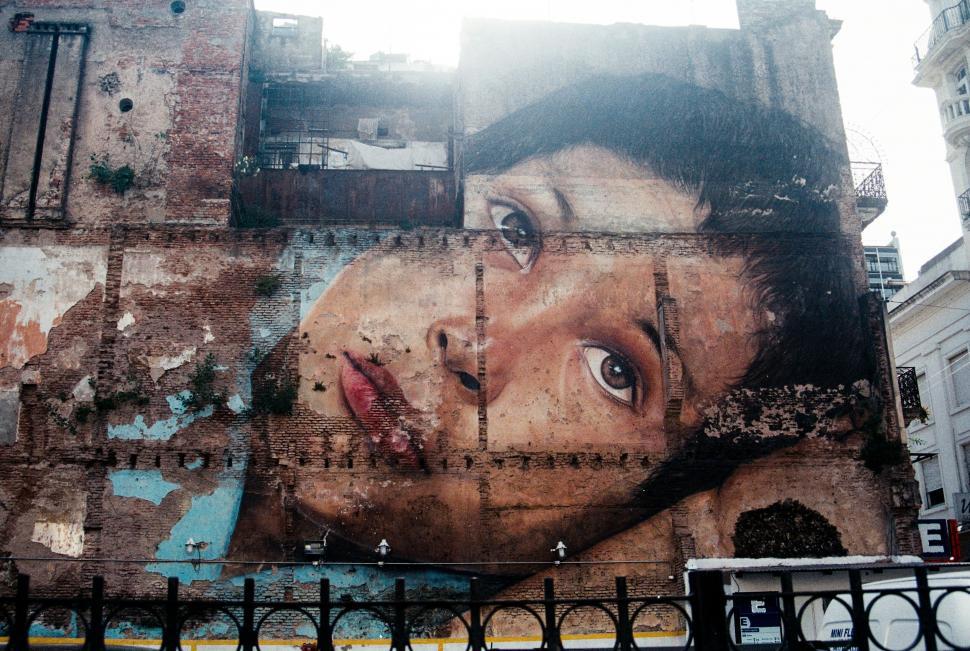 Free Image of Mural on building obscured by censoring 
