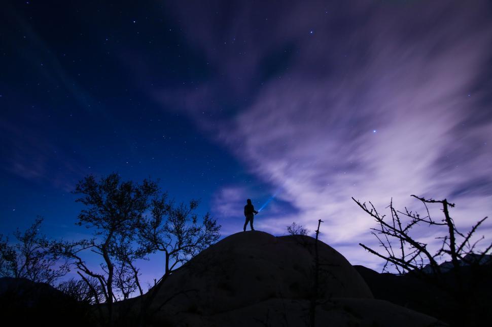 Free Image of Starry night sky with silhouette on rock 