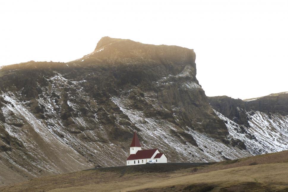 Free Image of Church at the base of a snow-capped mountain 