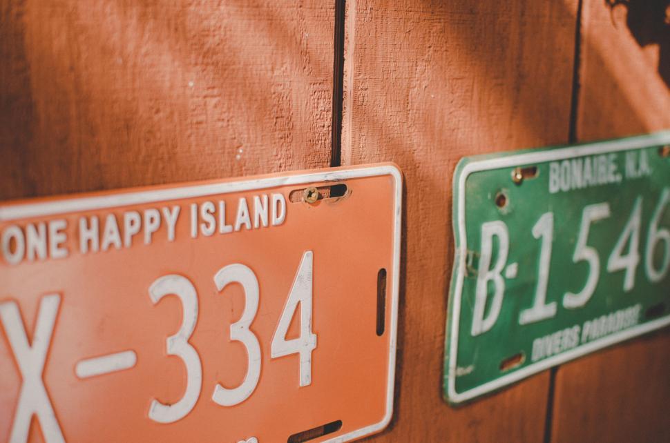 Free Image of Vehicle license plates on a wooden wall 