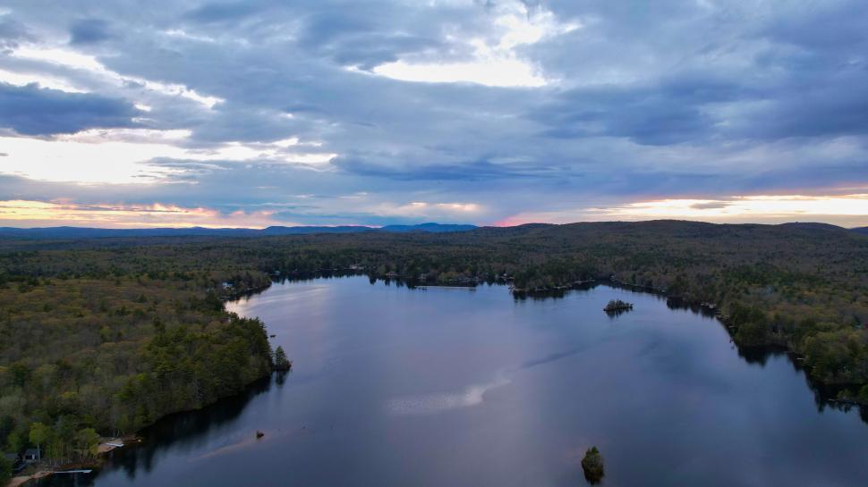 Free Image of Evening sky over tranquil forest lake 