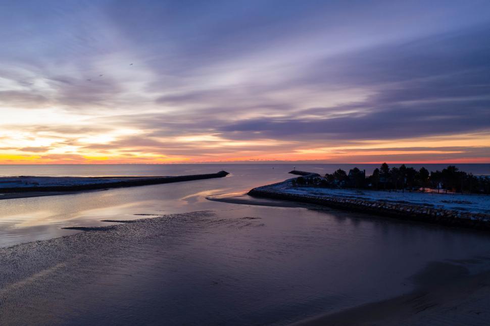 Free Image of Sunset over coastal waterway and beach 