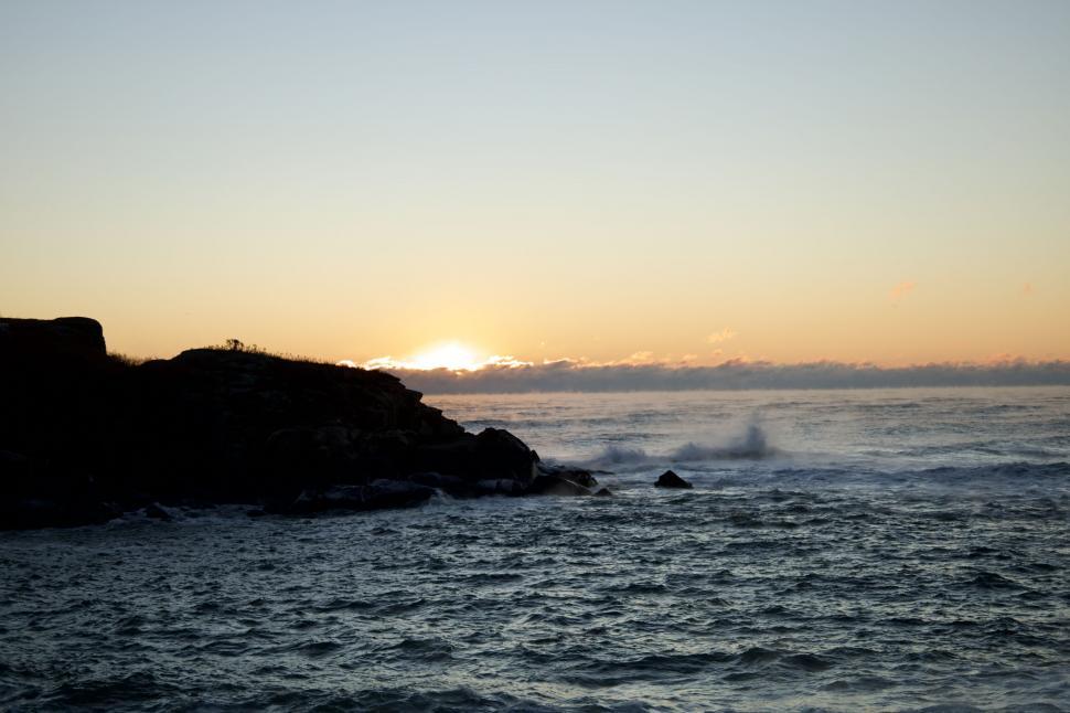 Free Image of Sunset view over rocky coastline 