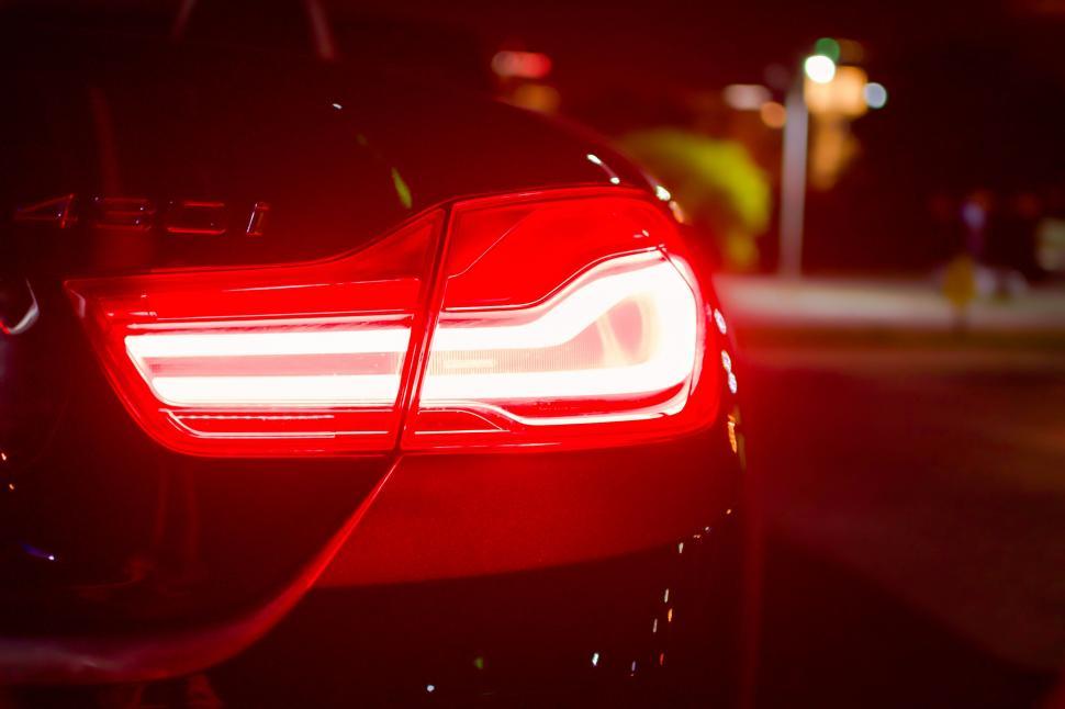 Free Image of Close-up of red car taillight at night 