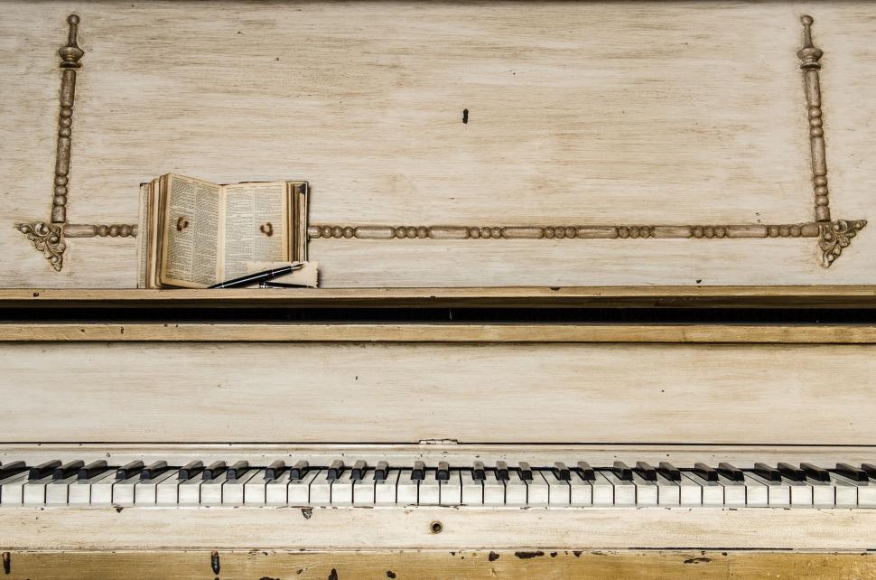 Free Image of Old-fashioned piano with book on music stand 