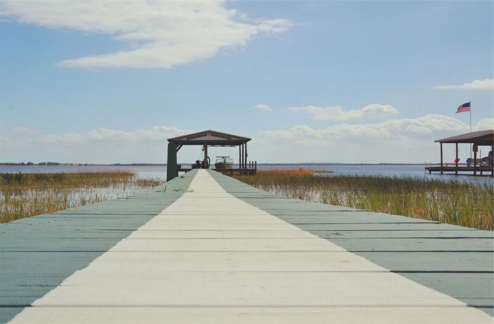 Free Image of Dock leading to a gazebo by the water 