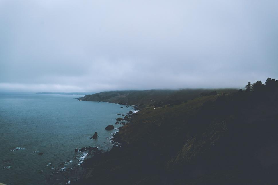 Free Image of Misty coastline with cliffs and ocean 