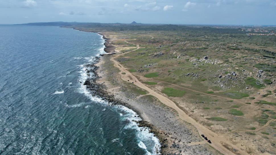 Free Image of Rocky coastline extending into the distance with ocean. 