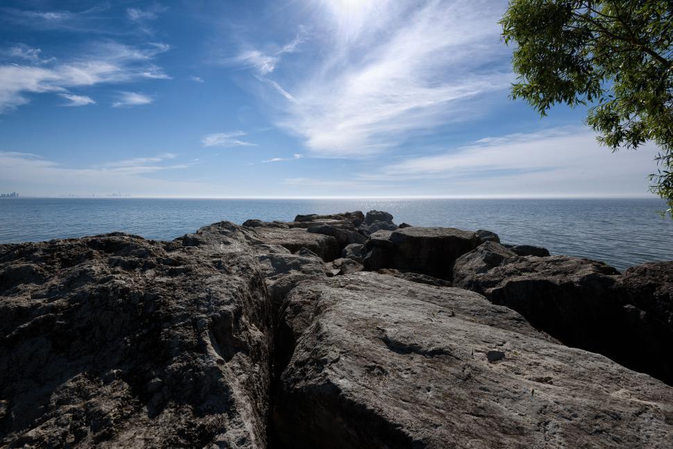 Free Image of Rocky coastline under a bright, clear sky. 
