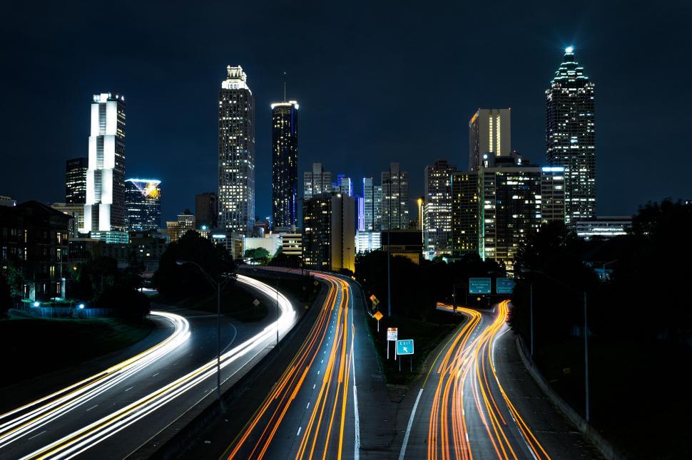 Free Image of Nighttime urban skyline with illuminating light trails. 