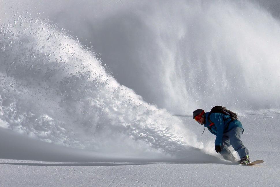 Free Image of Snowboarder carving through fresh powder snow 