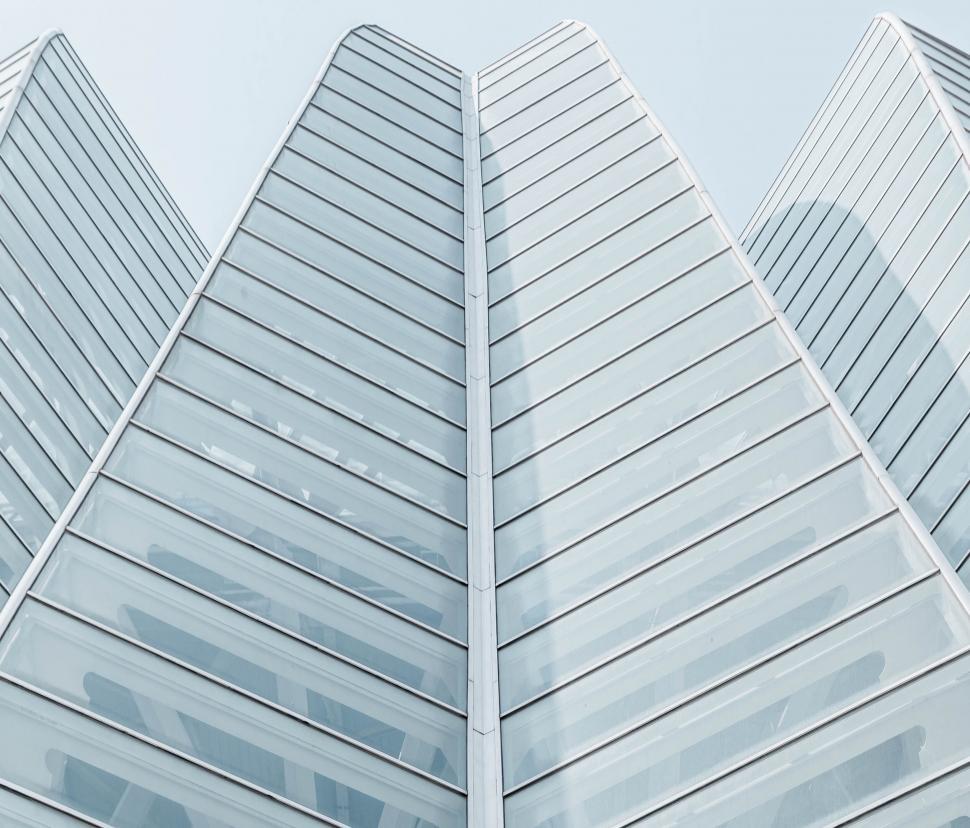 Free Image of Glass-covered futuristic building from low angle view. 