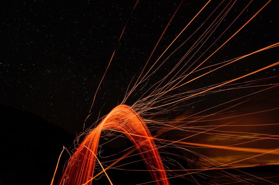 Free Image of Abstract light trails during night with a starry background 