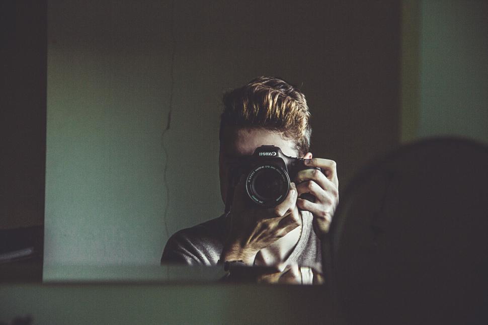 Free Image of Person with camera captures an image in a dark room 