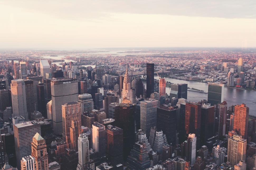 Free Image of Aerial view of city with skyscrapers during sunset time 