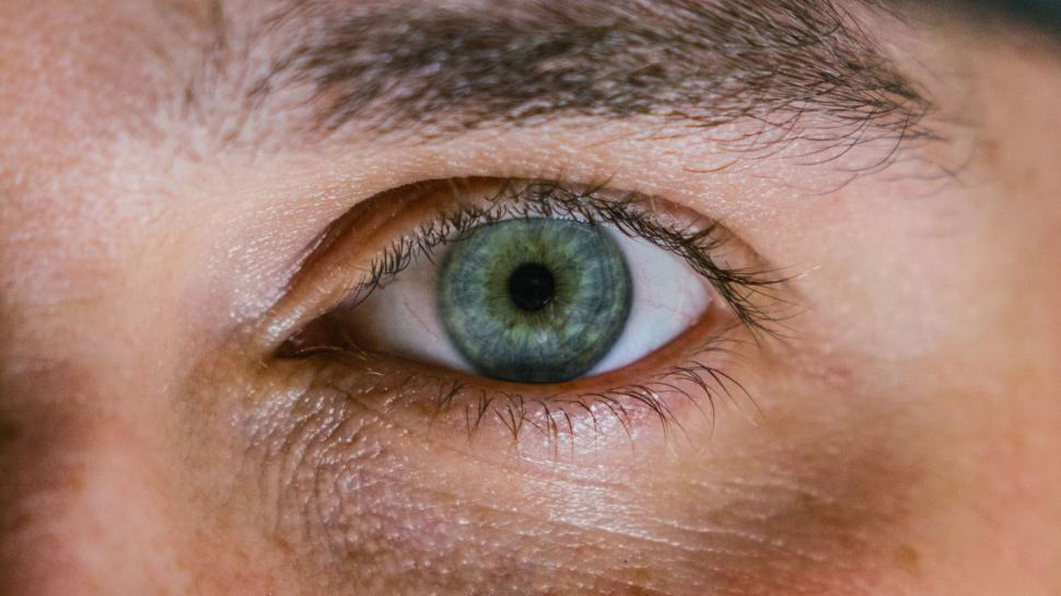 Free Image of Detailed macro shot of human green eye with lashes visible 