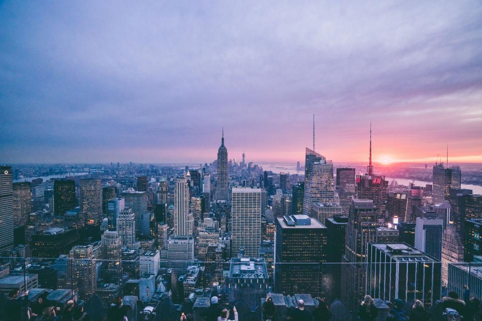 Free Image of Sunset over the bustling cityscape, skyscrapers in view. 