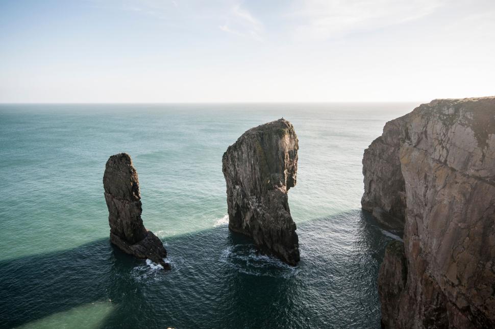 Free Image of Rock formations in the sea during daytime with clear sky 